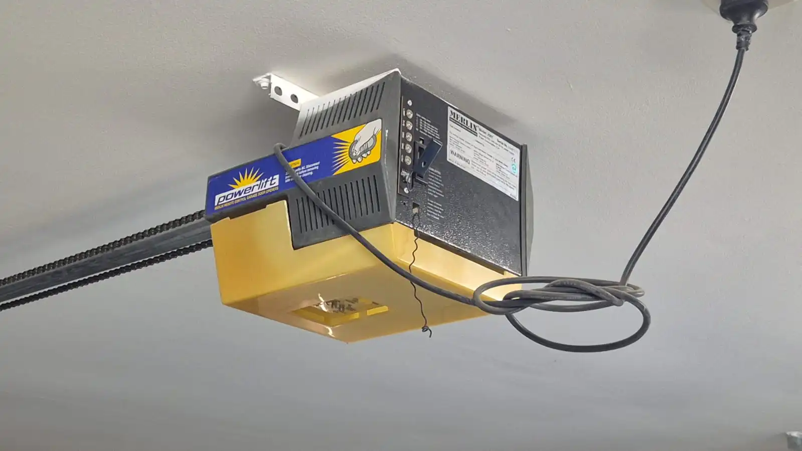 Ceiling-mounted garage door opener motor used for an automatic door upgrade